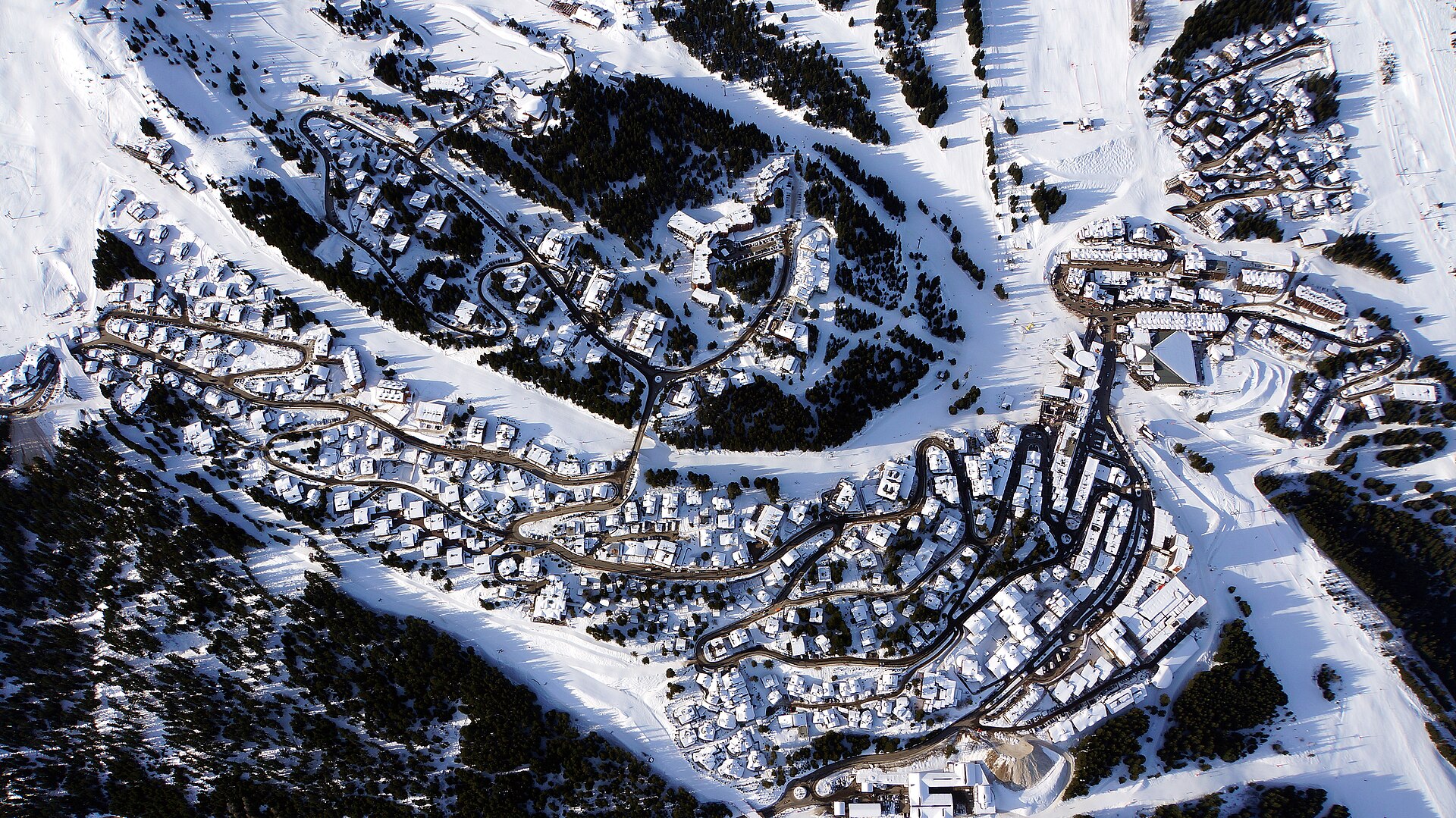Aerial winter view of Courchevel 1850 and its winding roads