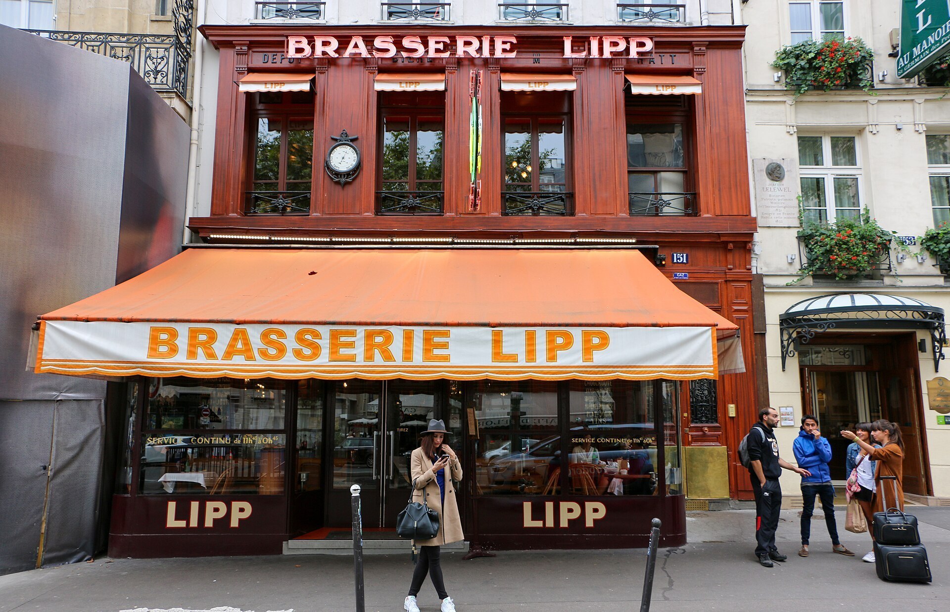 Red frontage of Brasserie Lipp on Boulevard Saint-Germain in Paris