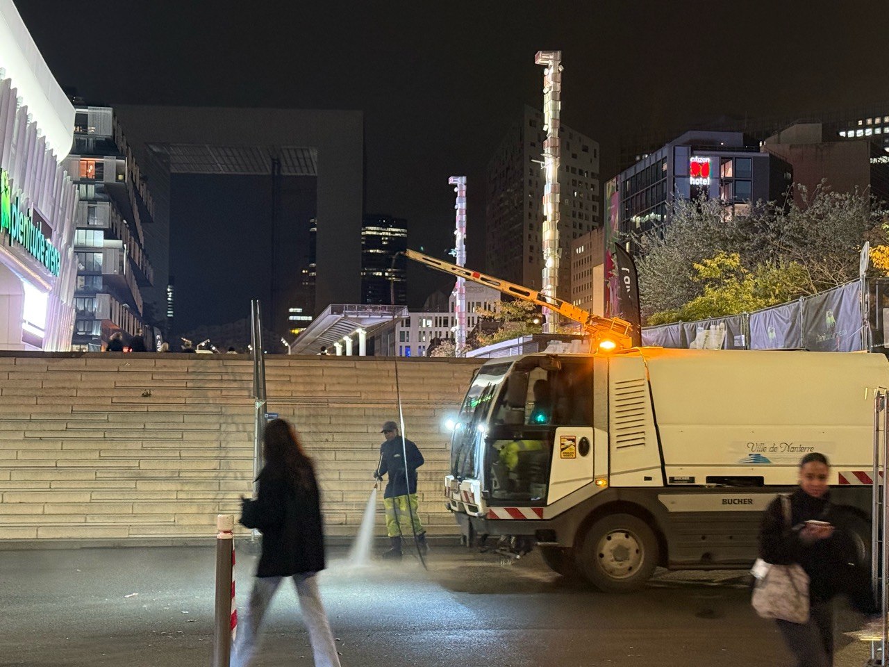 City of Nanterre cleaning worker washing the street after the Céline Dion concert