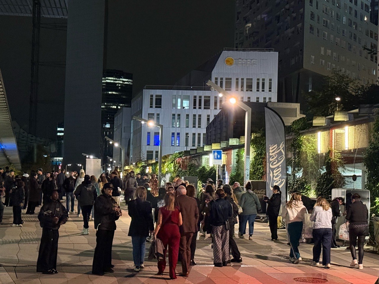 Concertgoers moving through La Défense after Céline Dion performance