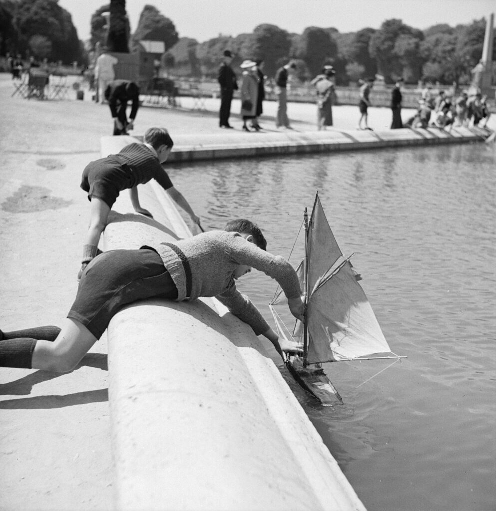 Des enfants font naviguer des petits voiliers au bassin du Jardin du Luxembourg à Paris