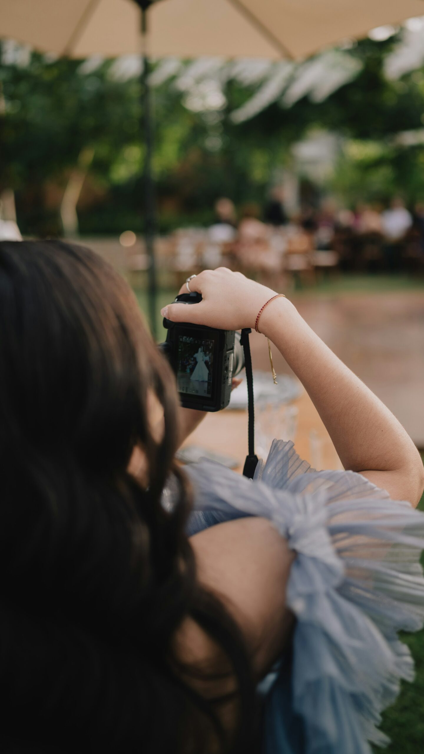 A man filming a wedding ceremony as the couple exchange vows