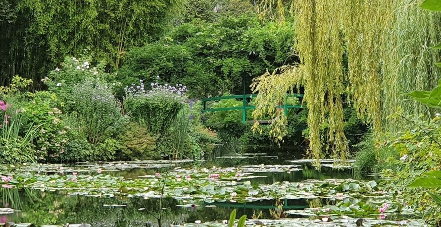 The green Japanese bridge and water-lily pond in Monet’s garden at Giverny