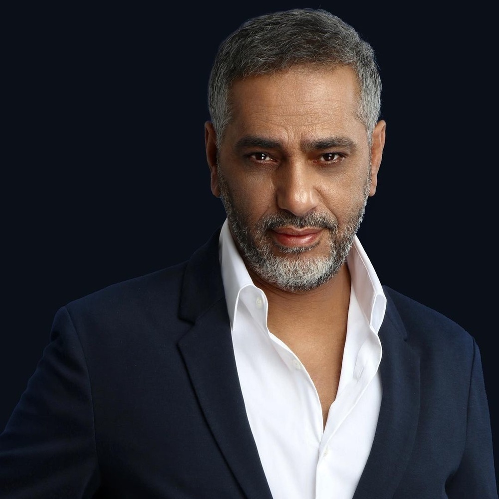 Close portrait of Fadel Shaker in a dark suit ahead of his Riyadh stage comeback