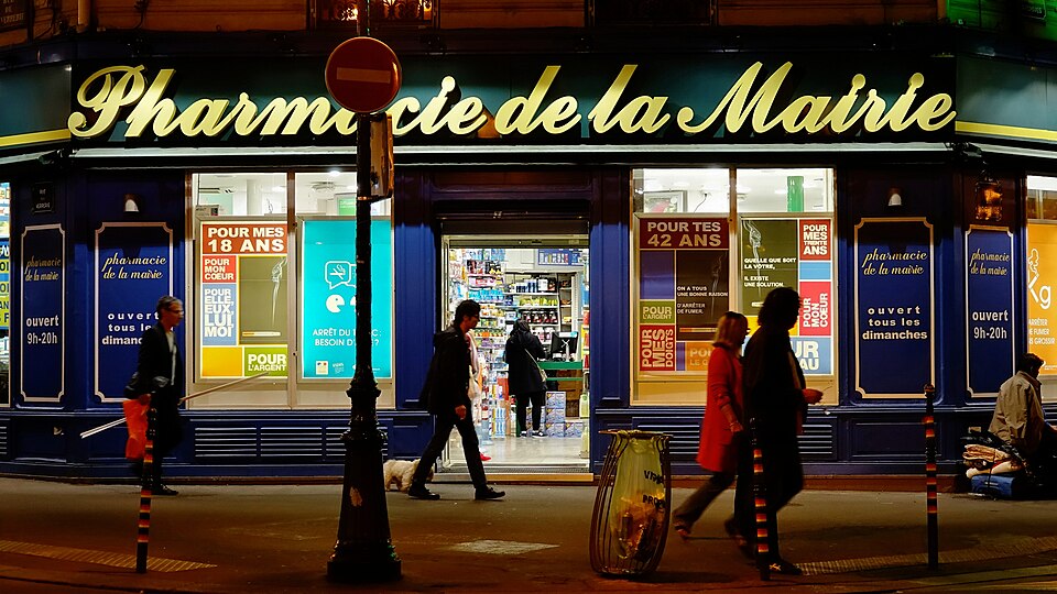 Pharmacie illuminée rue des Archives à Paris la nuit