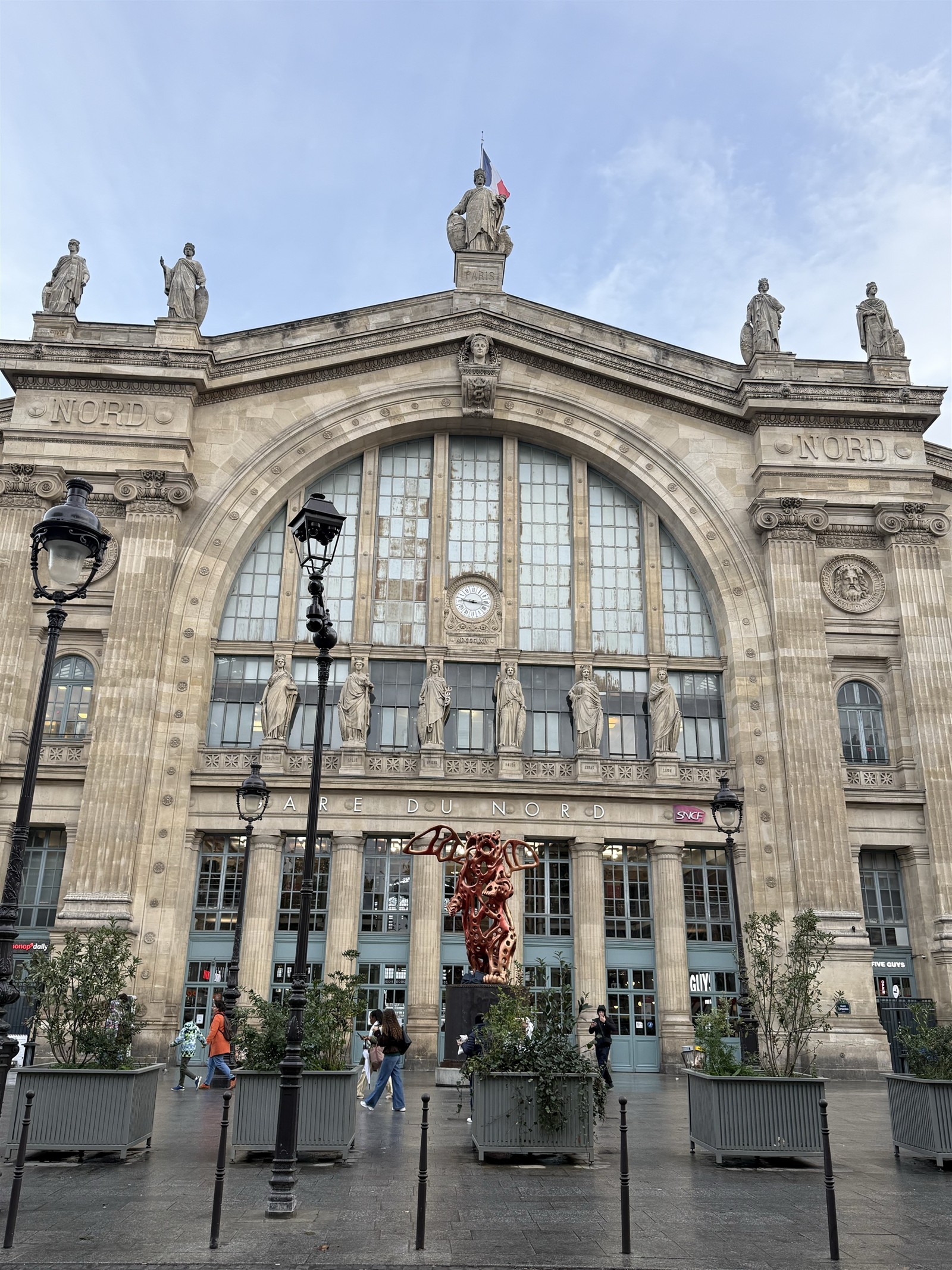 Main façade clock and statues of Paris Gare du Nord