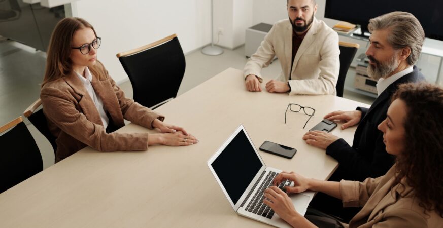 Professional team discussing work around a meeting table