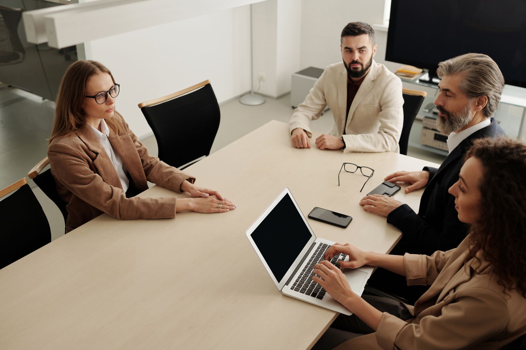 Professional team discussing work around a meeting table
