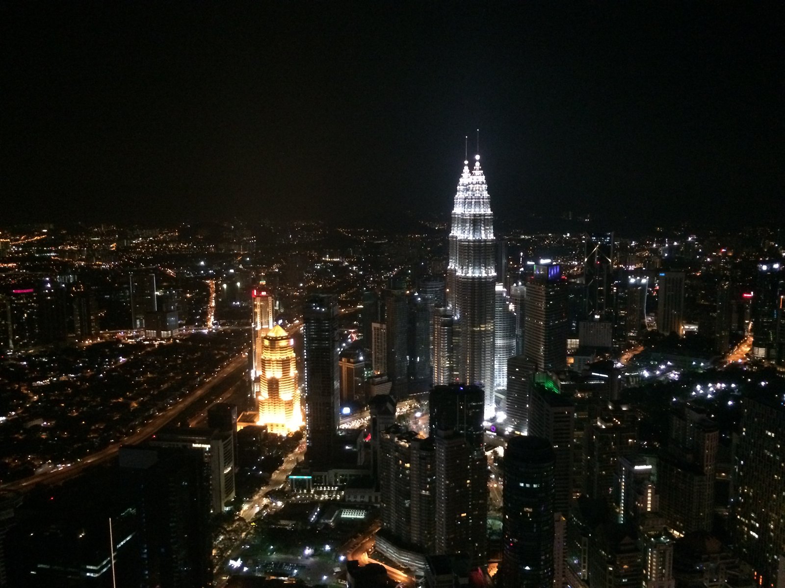 Illuminated Petronas Twin Towers and Kuala Lumpur skyline at night