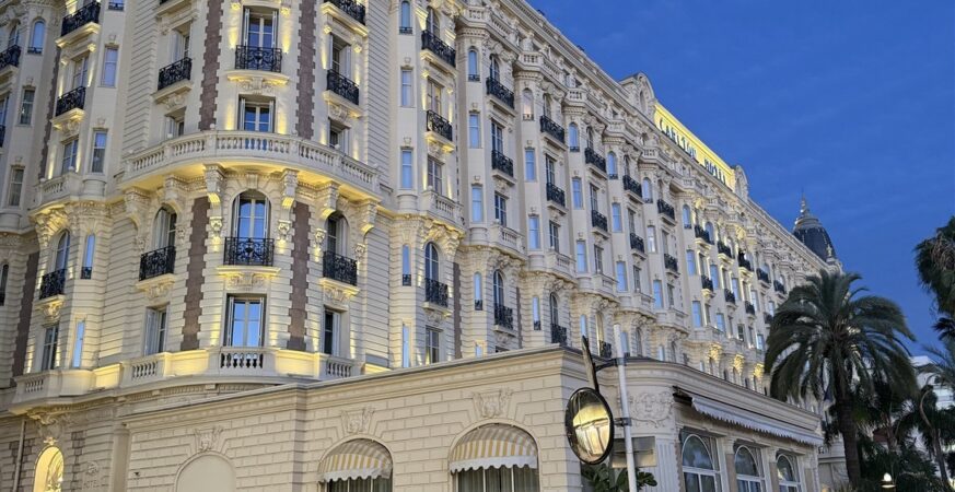 Illuminated facade of Carlton Cannes at dusk