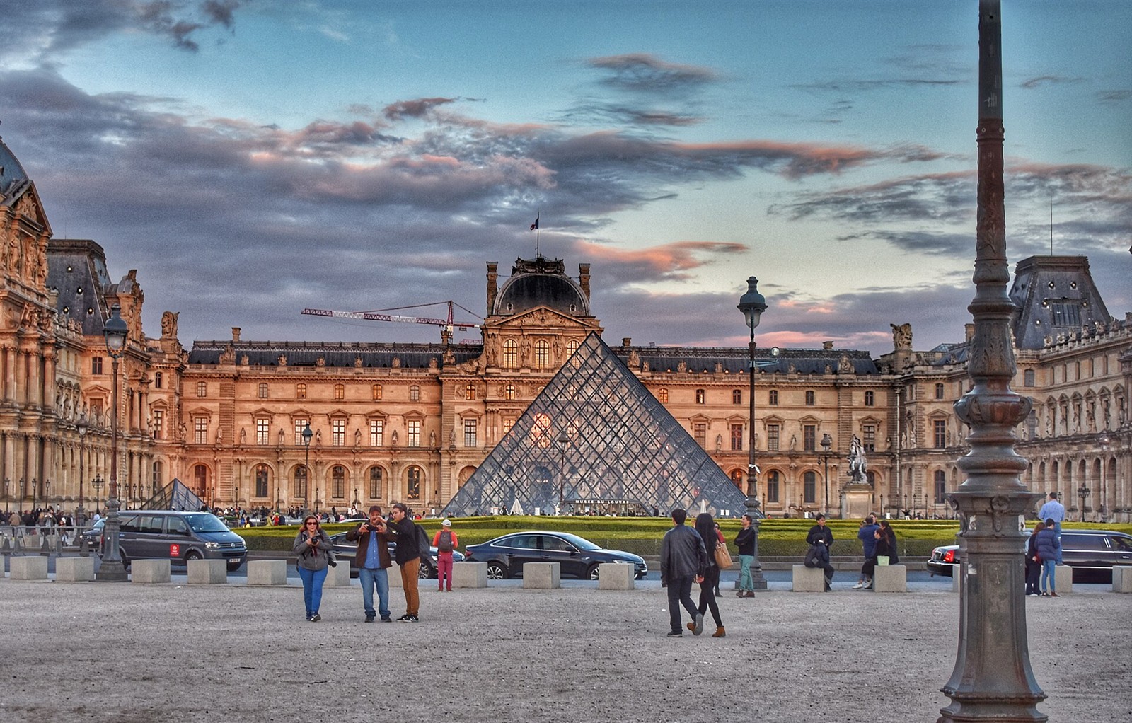 Louvre Pyramid and Cour Napoléon at sunset in Paris