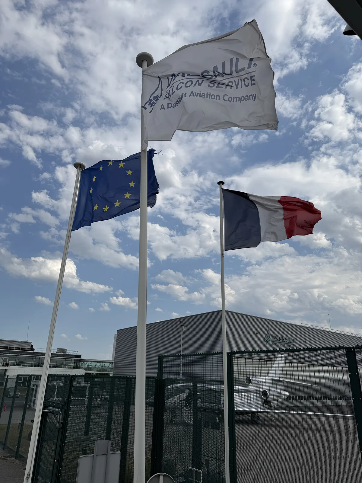 French and European flags outside Dassault Falcon Service at Le Bourget