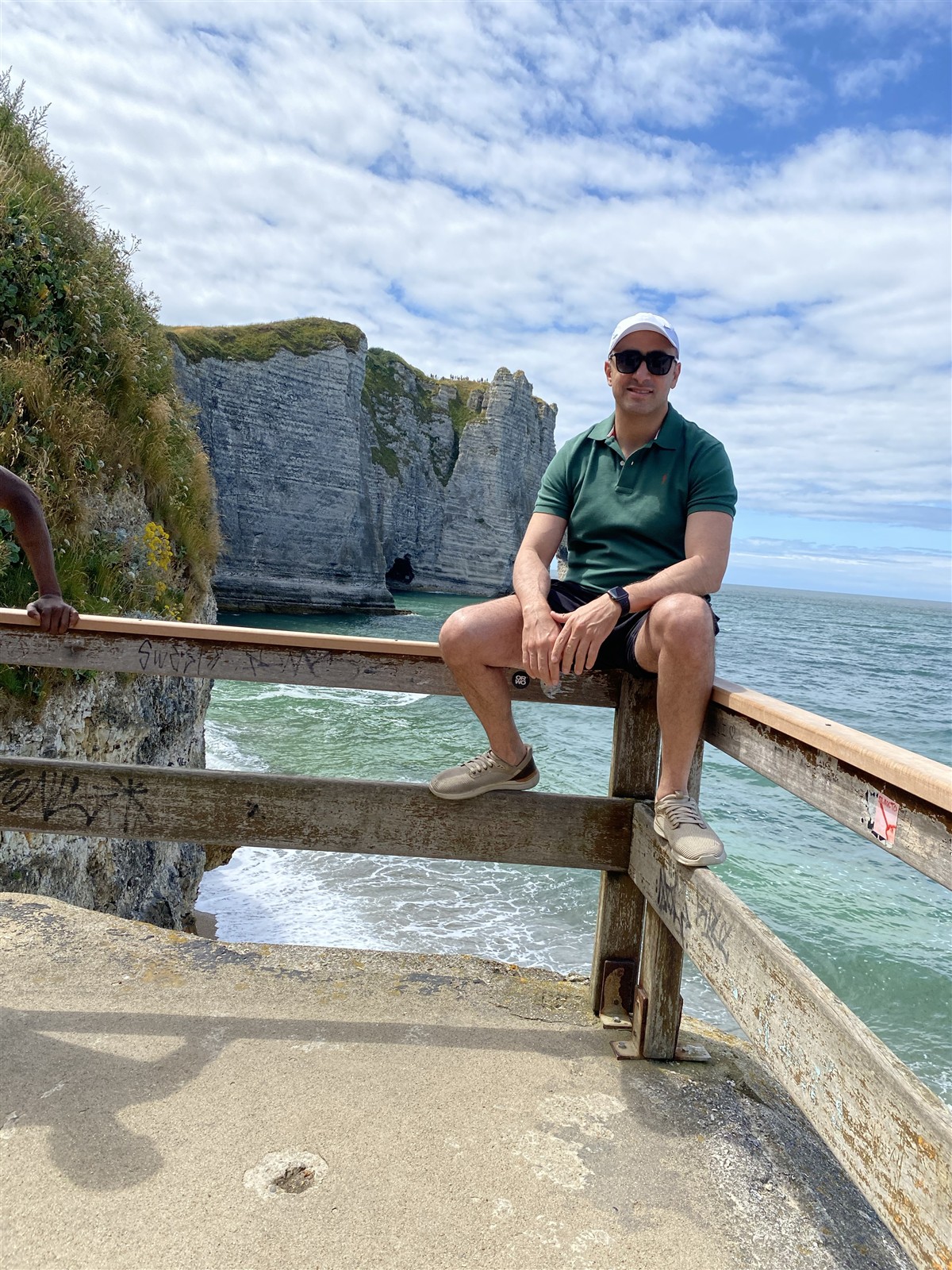 A personal photograph from the visit album in front of Étretat’s cliffs; follow site rules and do not climb barriers.