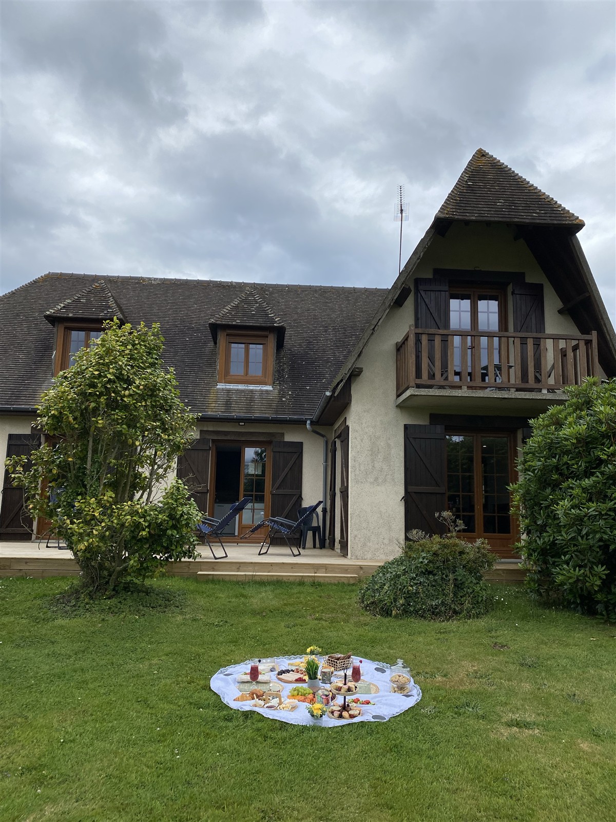 A house, garden and picnic spread in the rural part of the Normandy visit album.