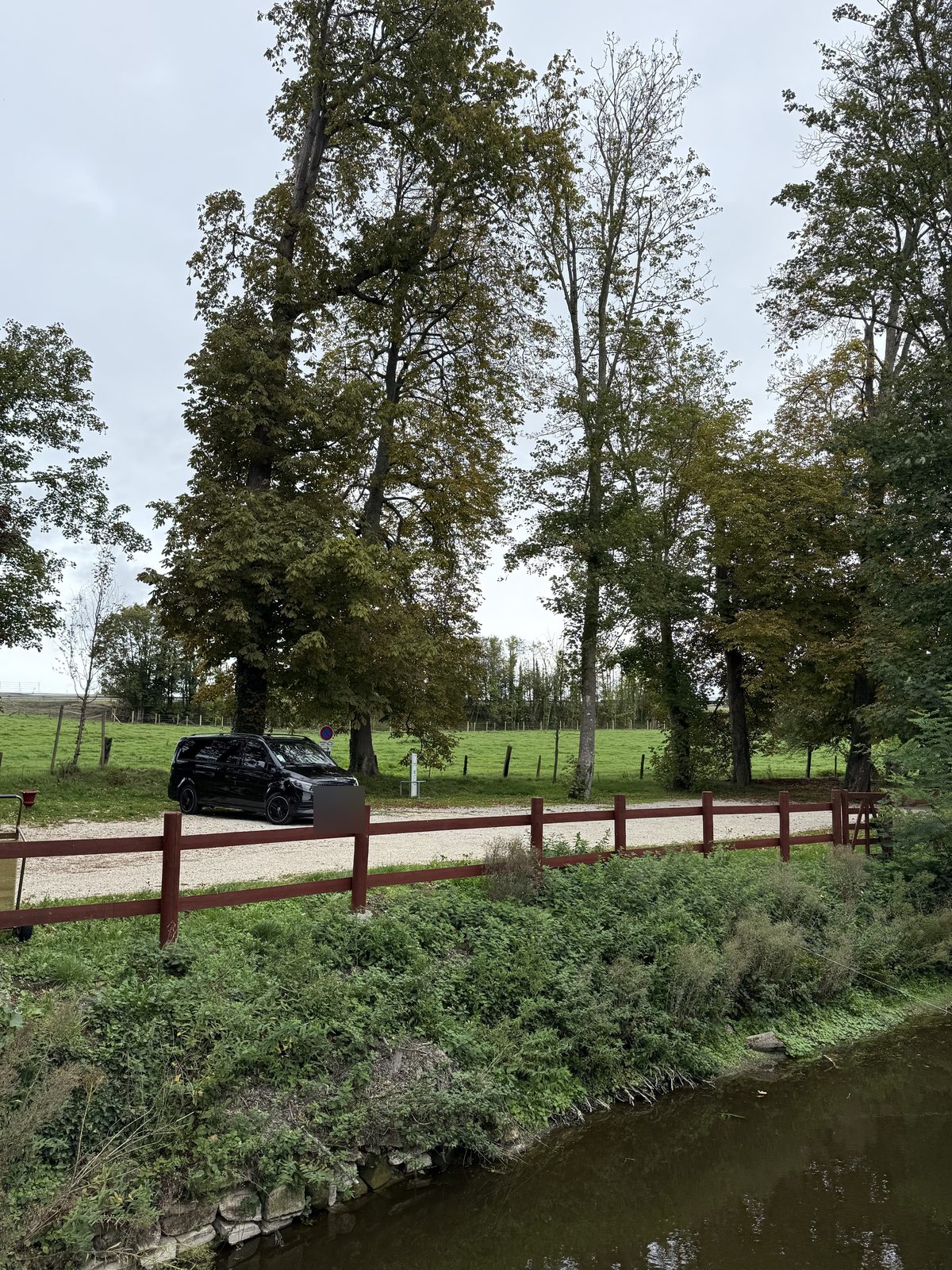 Private passenger vehicle among the trees and water of the Bellefontaine estate