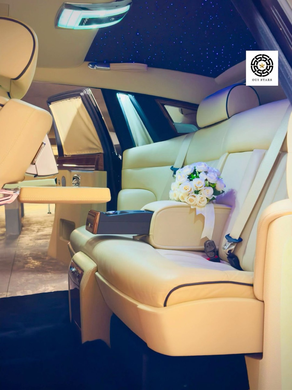 Cream Rolls-Royce wedding interior with white bouquet