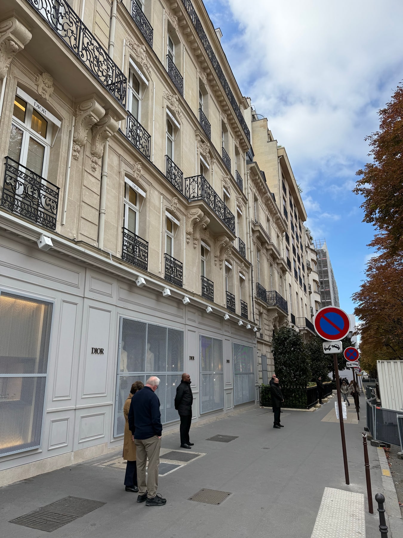 Security staff outside closed Dior storefronts in Paris on the morning of 18 October 2026