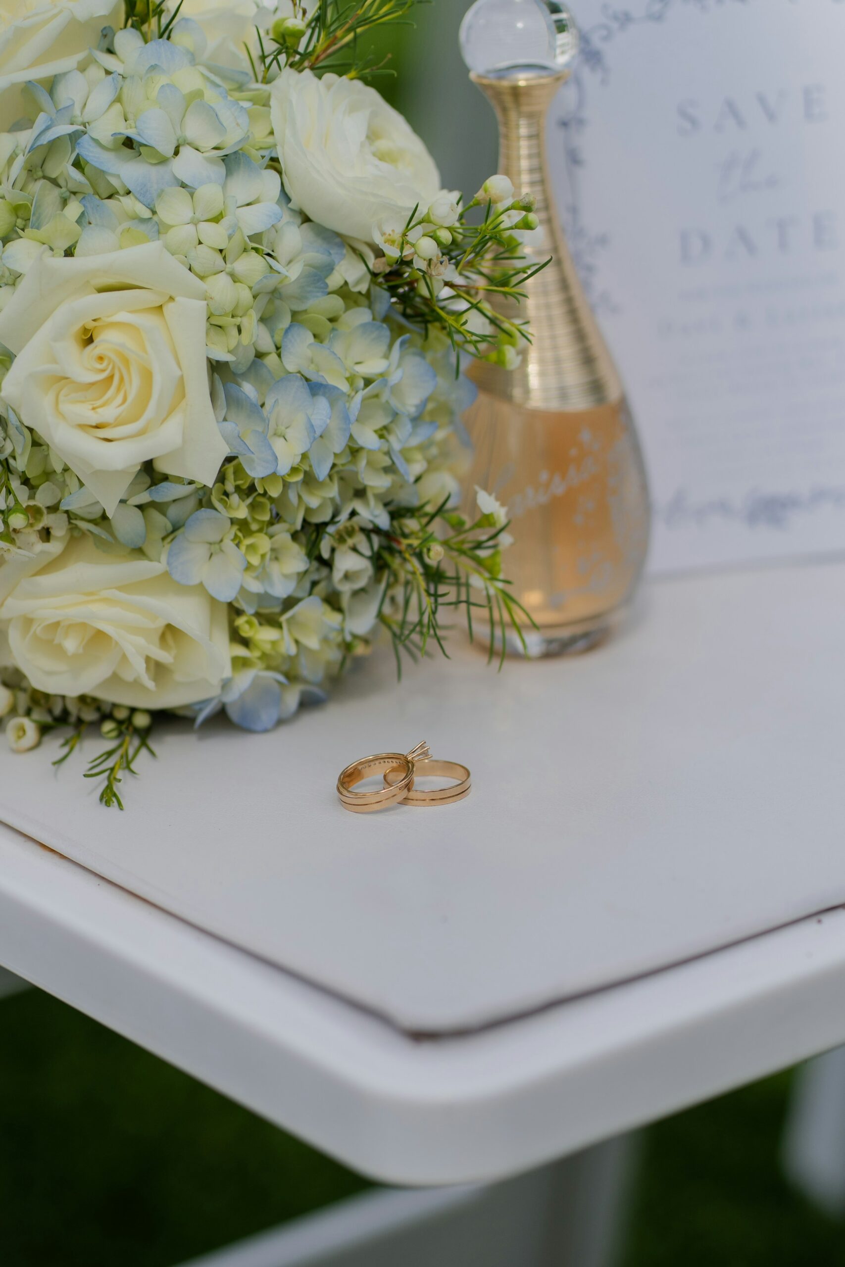 Wedding rings, champagne and bouquet
