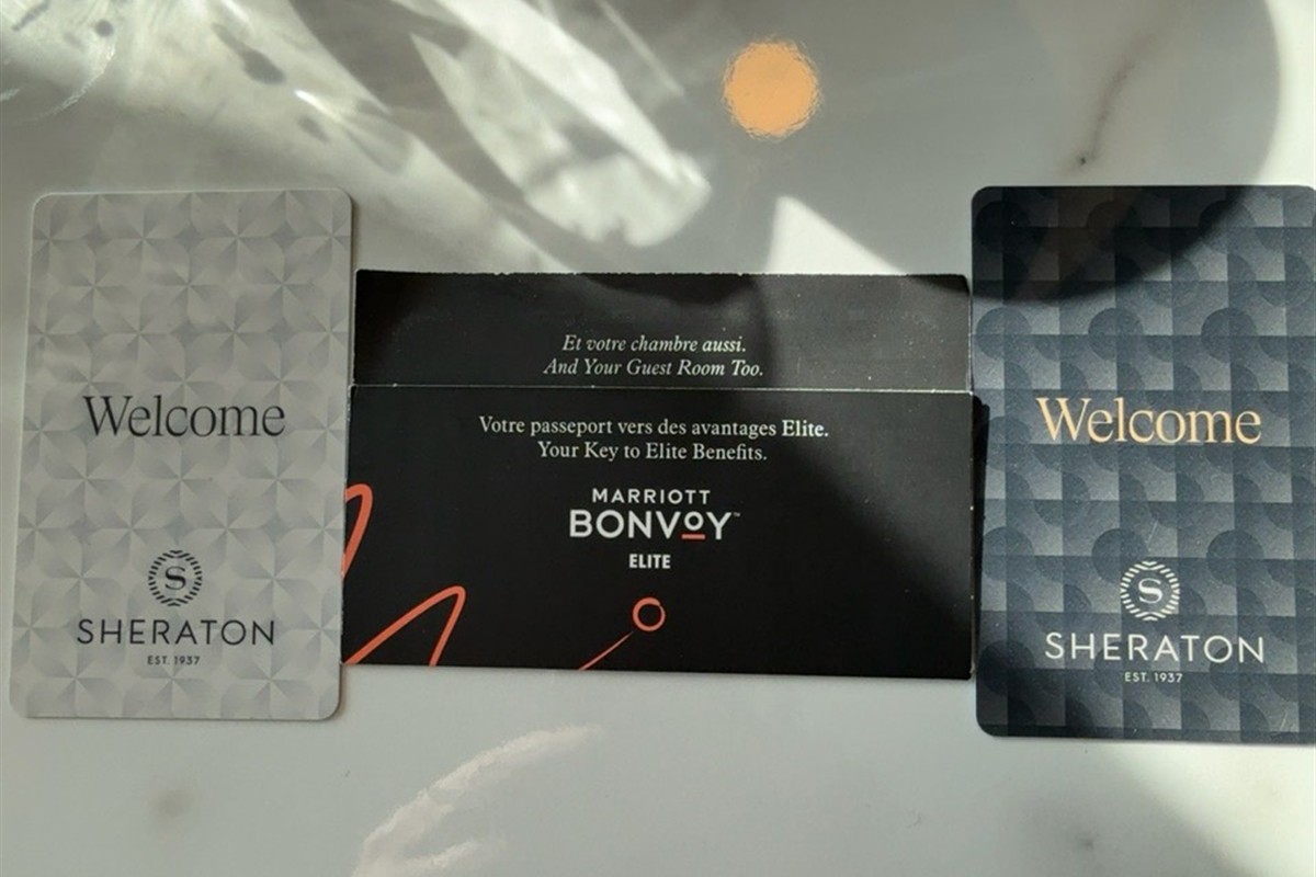 Two Sheraton room key cards and a Marriott Bonvoy sleeve on a table