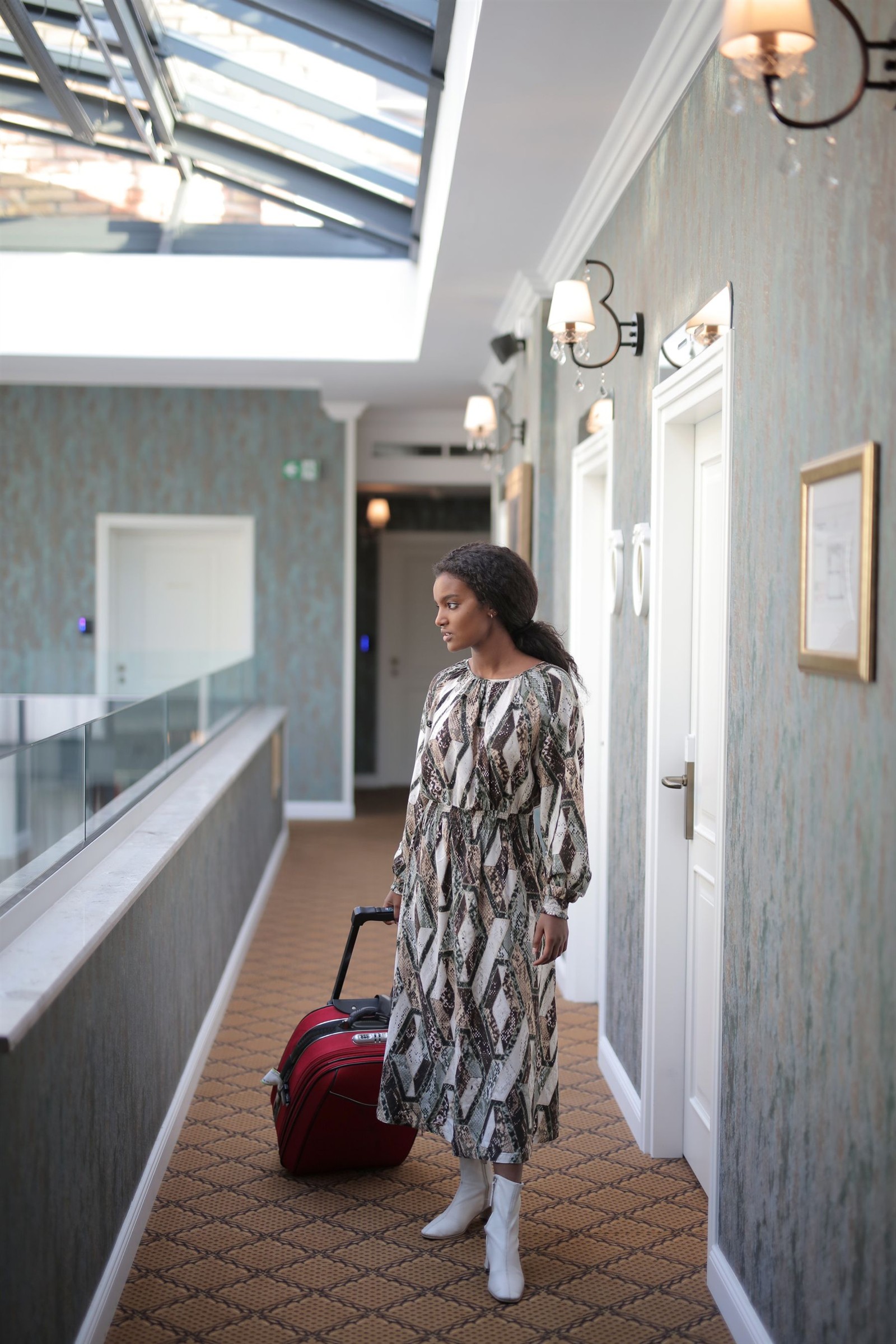 A traveller with luggage in a hotel — illustrative photograph.