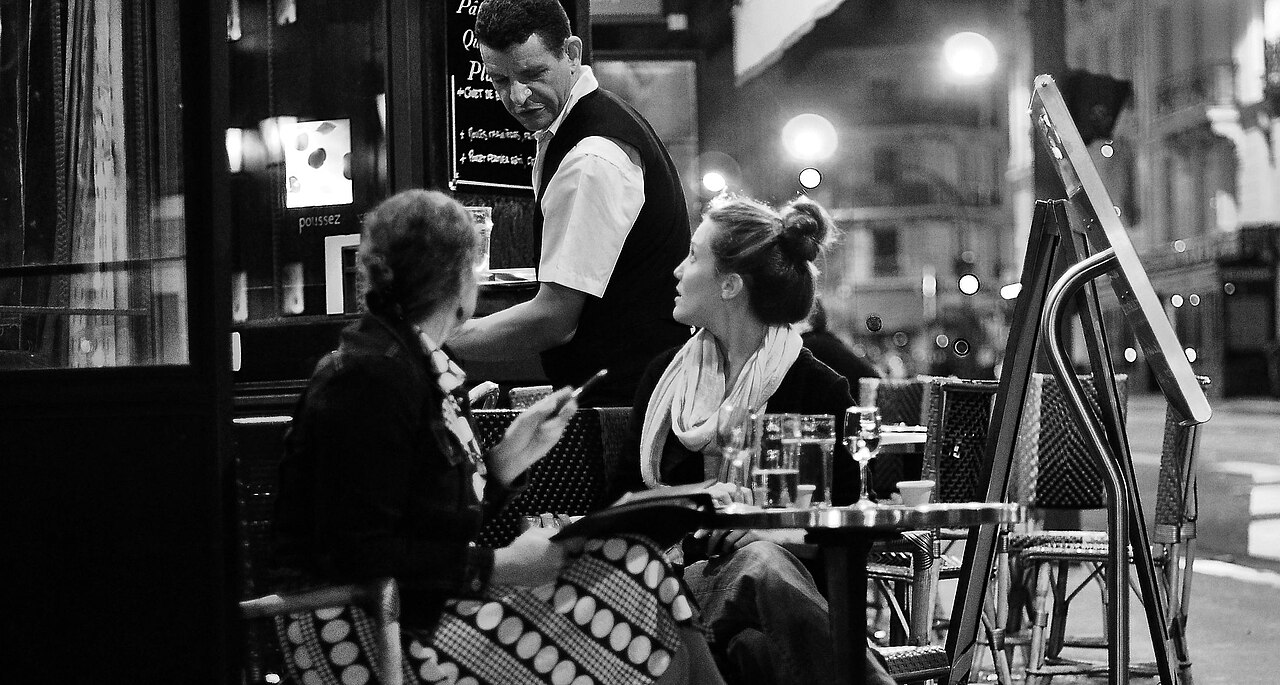 Two women talking at a café on Boulevard Saint-Michel in Paris