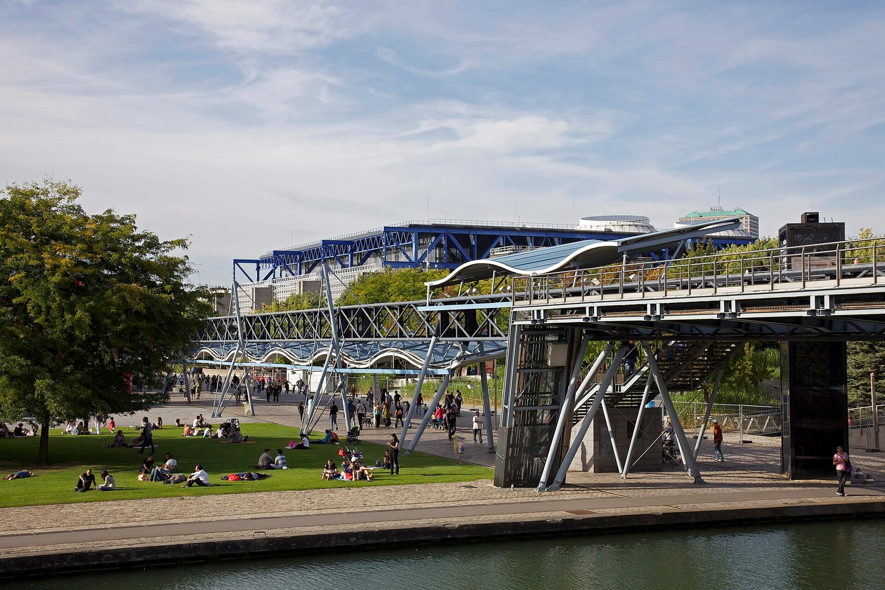 Families relaxing beside the Cité des sciences in Parc de la Villette, Paris