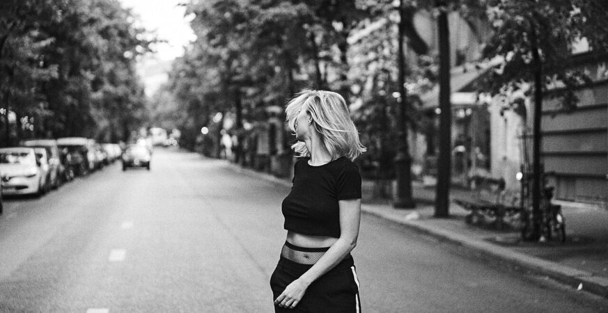 A woman walking independently along a Paris street