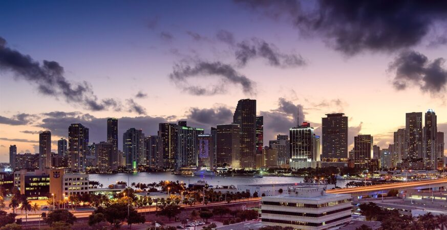 Illuminated Miami skyline on the waterfront at sunset