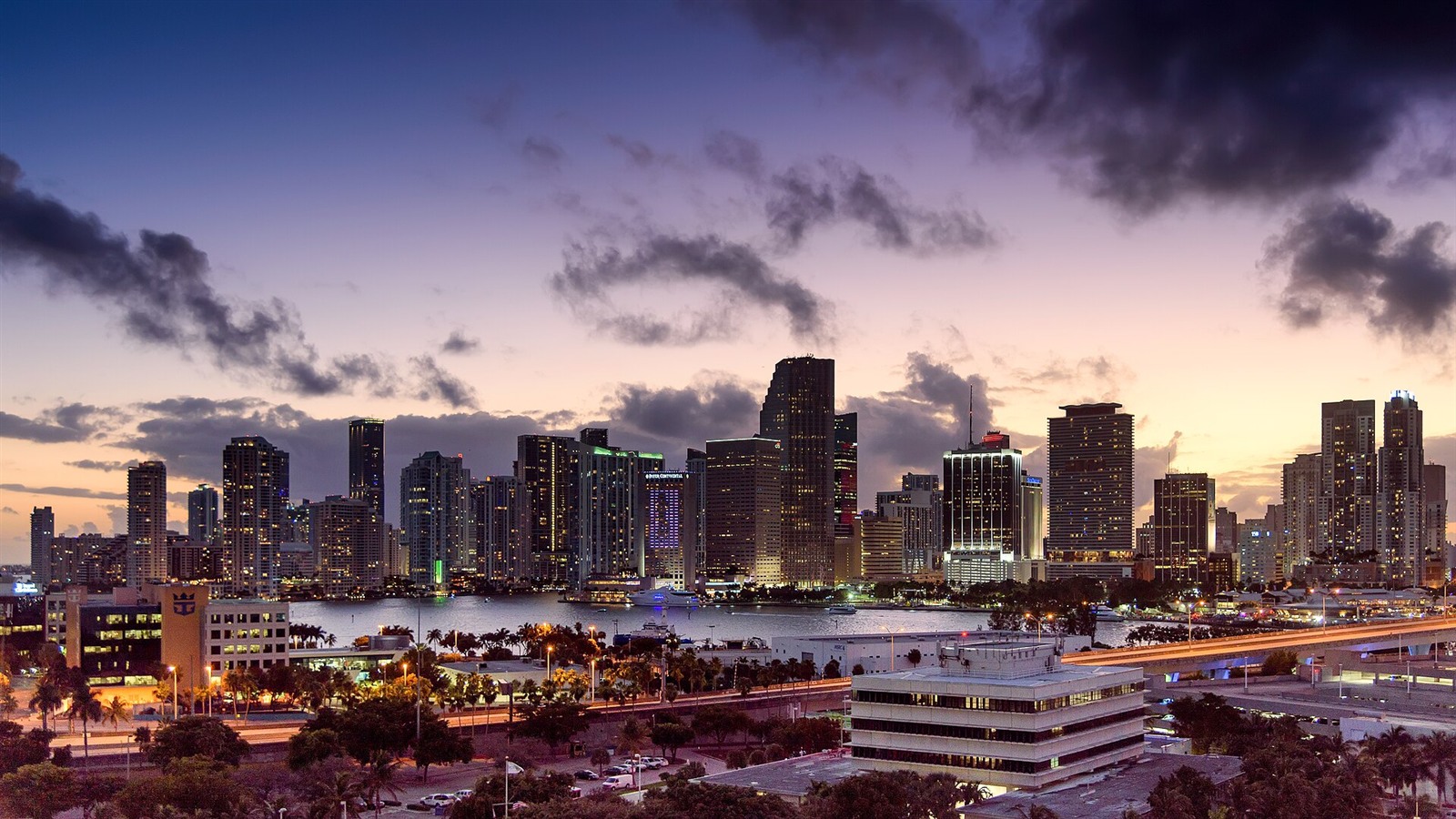 Illuminated Miami skyline on the waterfront at sunset