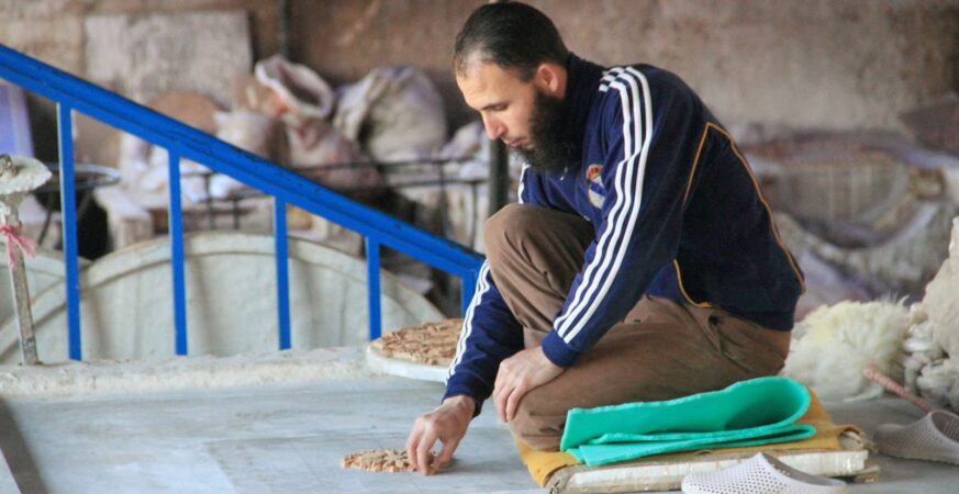 A zellige artisan at work in Fez: the maker’s face and hand are central to the Moroccan craft.